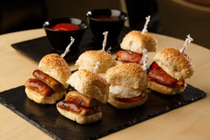 Bacon and sausage breakfast sliders on a slate, as part of mercure hotels meeting food offering