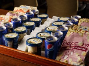 Tubs of ice cream and popcorn on a tray