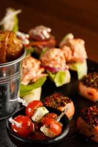 Selection of finger buffet food showing chips, and tomatoes with feta, as part of mercure hotels meeting food offering